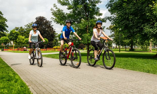 People riding bikes in a city park