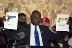 FILE - This Thursday, April 15, 2021, attorney Ben Crump, who represents Daunte Wright's family, is holding up pictures of an X26P Taser and Glock 17 during a press conference held at the New Salem Missionary Baptist Church in Minneapolis - Pistol pose.